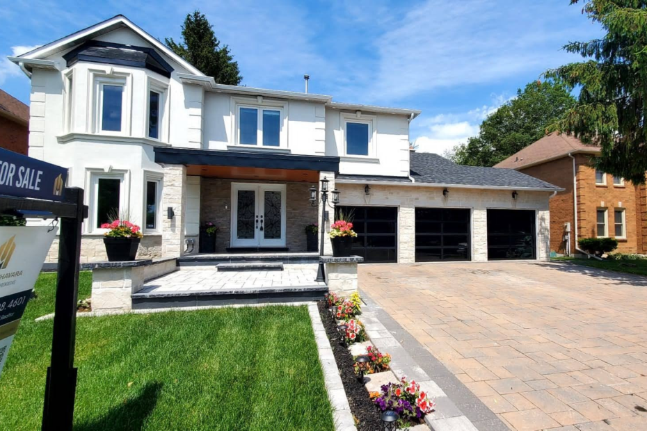 Clean shot of a three-car garage featuring black full view glass doors in Scarborough, Ontario installed by Dodds Garage Doors.